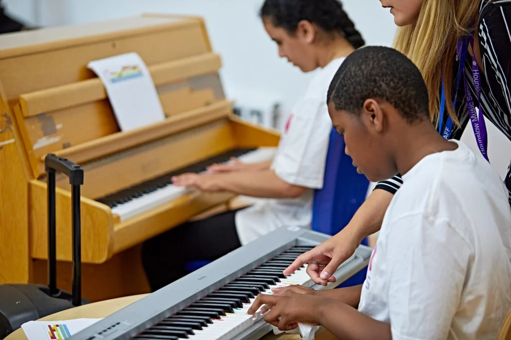 Two musicians playing the piano.